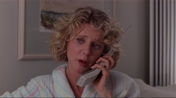 Movie still from “The Prince of Tides” (1991), directed by Barbra Streisand – A person talking on a cell phone; Close Up shot, High angle