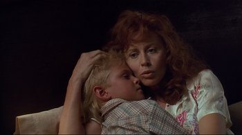 Movie still from “The Prince of Tides” (1991), directed by Barbra Streisand – A woman holding a child in her arms; Close Up shot, Low angle