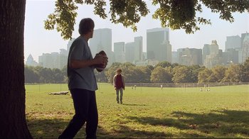 Movie still from “The Prince of Tides” (1991), directed by Barbra Streisand – Two people in a field with a city skyline in the background; Wide shot, Over the shoulder angle