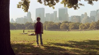 Movie still from “The Prince of Tides” (1991), directed by Barbra Streisand – A person standing in a field with a city skyline in the background; Extreme Wide shot, Low angle