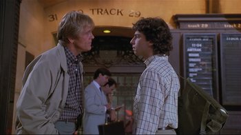 Movie still from “The Prince of Tides” (1991), directed by Barbra Streisand – Two men standing next to each other in front of a building; Medium shot, Over the shoulder angle