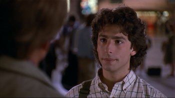 Movie still from “The Prince of Tides” (1991), directed by Barbra Streisand – A young man in a checkered shirt is looking to his left; Close Up shot, Over the shoulder angle