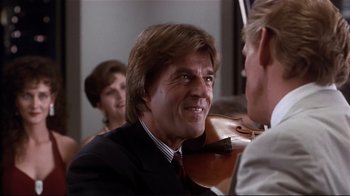 Movie still from “The Prince of Tides” (1991), directed by Barbra Streisand – A person holding a violin; Close Up shot, Over the shoulder angle