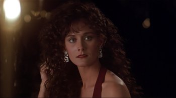 Movie still from “The Prince of Tides” (1991), directed by Barbra Streisand – A beautiful woman with long curly hair wearing a red dress; Close Up shot, Over the shoulder angle