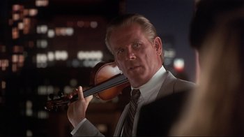Movie still from “The Prince of Tides” (1991), directed by Barbra Streisand – A person holding a violin; Close Up shot, Over the shoulder angle