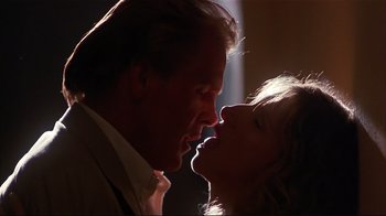 Movie still from “The Prince of Tides” (1991), directed by Barbra Streisand – A man and a woman kissing in the dark; Close Up shot, Low angle