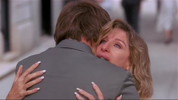 Movie still from “The Prince of Tides” (1991), directed by Barbra Streisand – A man and a woman hugging each other in front of a building; Close Up shot, Over the shoulder angle