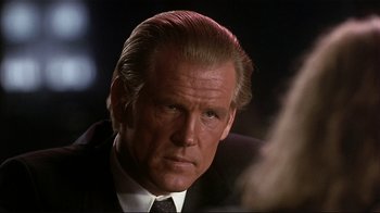 Movie still from “The Prince of Tides” (1991), directed by Barbra Streisand – A man in a suit and tie; Close Up shot, Over the shoulder angle