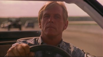 Movie still from “The Prince of Tides” (1991), directed by Barbra Streisand – A person driving a car on the road; Close Up shot, Low angle