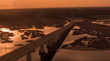 Movie still from “The Prince of Tides” (1991), directed by Barbra Streisand – An aerial view of a bridge over a body of water; Extreme Wide shot, High angle