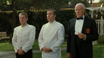 Movie still from “The Princess Diaries” (2001), directed by Garry Marshall – A group of men standing next to each other in formal wear; Medium shot, Low angle