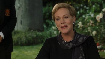 Movie still from “The Princess Diaries” (2001), directed by Garry Marshall – A person sitting in a chair wearing a scarf; Close Up shot, Over the shoulder angle