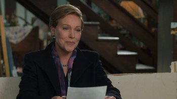 Movie still from “The Princess Diaries” (2001), directed by Garry Marshall – A woman sitting at a table holding a piece of paper; Medium shot, Over the shoulder angle