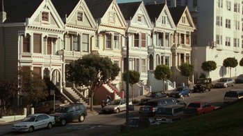 Movie still from “The Princess Diaries” (2001), directed by Garry Marshall – A row of houses on a street with cars parked on the side of the road; Extreme Wide shot, High angle