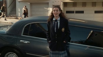 Movie still from “The Princess Diaries” (2001), directed by Garry Marshall – A girl in a school uniform standing in front of a car; Medium shot, High angle