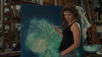 Movie still from “The Princess Diaries” (2001), directed by Garry Marshall – A woman standing in front of a painting of an ocean wave; Medium shot, Over the shoulder angle