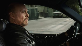 Movie still from “The Princess Diaries” (2001), directed by Garry Marshall – A man in a leather jacket driving a car; Close Up shot, Over the shoulder angle