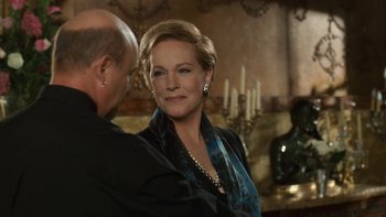 Movie still from “The Princess Diaries” (2001), directed by Garry Marshall – A man and a woman standing next to each other in front of candles; Close Up shot, Over the shoulder angle