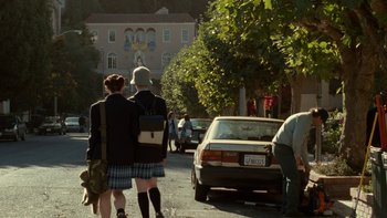 Movie still from “The Princess Diaries” (2001), directed by Garry Marshall – A couple of people that are walking down the street; Wide shot, Over the shoulder angle