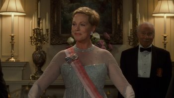 Movie still from “The Princess Diaries” (2001), directed by Garry Marshall – A woman in a dress with a sash around her waist; Medium shot, Over the shoulder angle