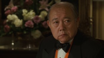 Movie still from “The Princess Diaries” (2001), directed by Garry Marshall – An older man wearing a tuxedo and a bow tie; Close Up shot, Over the shoulder angle