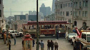 Movie still from “The Princess Diaries” (2001), directed by Garry Marshall – A group of people standing on the side of a street next to a trolley car; Extreme Wide shot, High angle