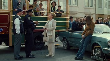 Movie still from “The Princess Diaries” (2001), directed by Garry Marshall – A woman standing on the side of a street; Wide shot, Over the shoulder angle