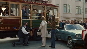 Movie still from “The Princess Diaries” (2001), directed by Garry Marshall – A group of people standing in front of a trolley car; Wide shot, Over the shoulder angle