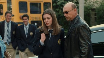 Movie still from “The Princess Diaries” (2001), directed by Garry Marshall – A man and a woman standing next to each other in front of a school bus; Medium shot, Over the shoulder angle