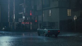 Movie still from “The Princess Diaries” (2001), directed by Garry Marshall – A car parked on the side of the road in the rain; Extreme Wide shot, High angle