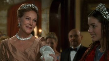 Movie still from “The Princess Diaries” (2001), directed by Garry Marshall – A woman wearing a tiara and holding something in her hand; Close Up shot, Over the shoulder angle