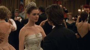 Movie still from “The Princess Diaries” (2001), directed by Garry Marshall – A woman wearing a tiara standing next to a man in a tuxedo; Close Up shot, Over the shoulder angle