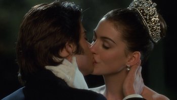 Movie still from “The Princess Diaries” (2001), directed by Garry Marshall – A man and a woman kissing each other in front of trees; Close Up shot, Over the shoulder angle