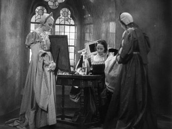 Movie still from “The Private Life of Henry VIII” (1933), directed by Alexander Korda – A group of women in medieval dress in a room with stained glass windows; Wide shot, High angle