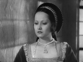 Movie still from “The Private Life of Henry VIII” (1933), directed by Alexander Korda – A black and white photo of a woman in a medieval dress; Close Up shot, High angle