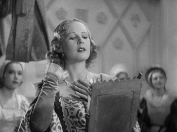 Movie still from “The Private Life of Henry VIII” (1933), directed by Alexander Korda – An old photo of a woman looking in a mirror; Medium shot, Low angle