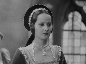 Movie still from “The Private Life of Henry VIII” (1933), directed by Alexander Korda – An old photo of a woman in a medieval dress; Close Up shot, High angle