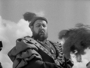 Movie still from “The Private Life of Henry VIII” (1933), directed by Alexander Korda – A man with a beard and a hat on; Close Up shot, Low angle
