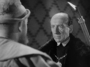 Movie still from “The Private Life of Henry VIII” (1933), directed by Alexander Korda – An old photo of a priest looking at himself in the mirror; Close Up shot, Over the shoulder angle