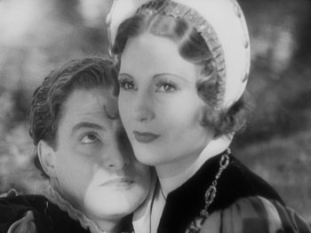 Movie still from “The Private Life of Henry VIII” (1933), directed by Alexander Korda – An old photo of a woman and a young man; Close Up shot, High angle