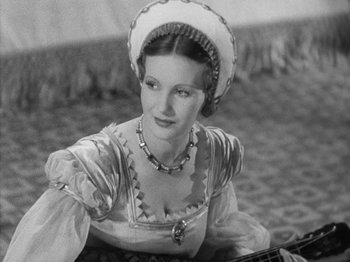 Movie still from “The Private Life of Henry VIII” (1933), directed by Alexander Korda – An old photo of a woman in a medieval dress; Medium shot, High angle