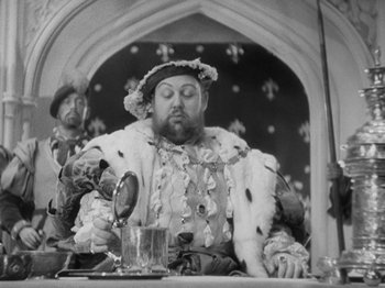Movie still from “The Private Life of Henry VIII” (1933), directed by Alexander Korda – Two men in medieval garb sitting in front of a mirror; Medium shot, Low angle