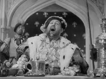 Movie still from “The Private Life of Henry VIII” (1933), directed by Alexander Korda – An old photo of a man in a medieval costume; Medium shot, Low angle