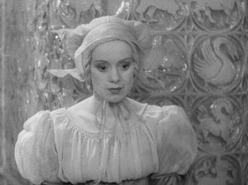Movie still from “The Private Life of Henry VIII” (1933), directed by Alexander Korda – A black and white photo of a woman wearing a hat; Medium shot, High angle