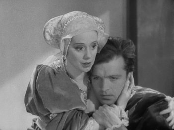 Movie still from “The Private Life of Henry VIII” (1933), directed by Alexander Korda – A man and a woman dressed in medieval clothing; Medium shot, High angle