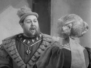 Movie still from “The Private Life of Henry VIII” (1933), directed by Alexander Korda – An old photo of a man and a woman dressed up; Close Up shot, Over the shoulder angle