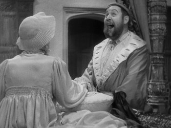 Movie still from “The Private Life of Henry VIII” (1933), directed by Alexander Korda – A man and a woman in period clothing are laughing; Medium shot, Over the shoulder angle