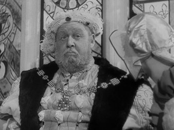 Movie still from “The Private Life of Henry VIII” (1933), directed by Alexander Korda – An older man wearing a crown and a fur coat; Close Up shot, Over the shoulder angle