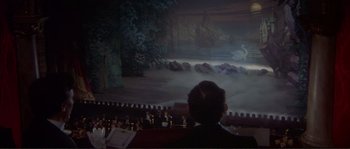 Movie still from “The Private Life of Sherlock Holmes” (1970), directed by Billy Wilder – A man sitting in front of an audience watching a performance; Extreme Wide shot, High angle