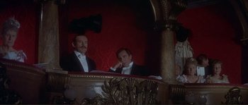 Movie still from “The Private Life of Sherlock Holmes” (1970), directed by Billy Wilder – Two men sitting at a table in a theater; Medium shot, Low angle